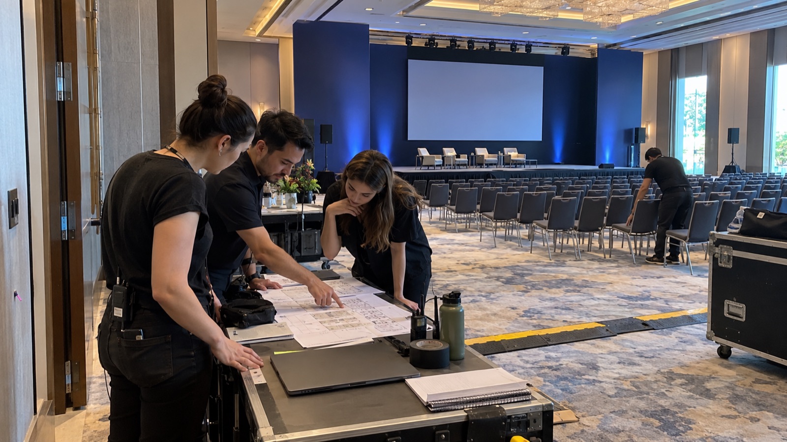 An event production team reviewing the room layout before opening