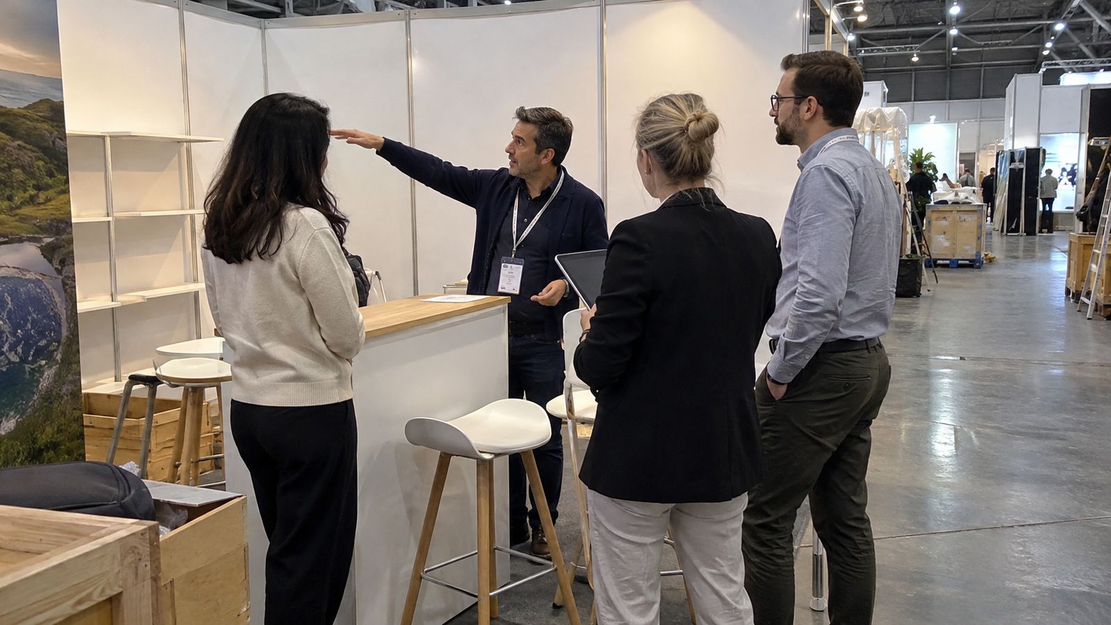 An international exhibitor team receives a stand briefing before the exhibition opens.