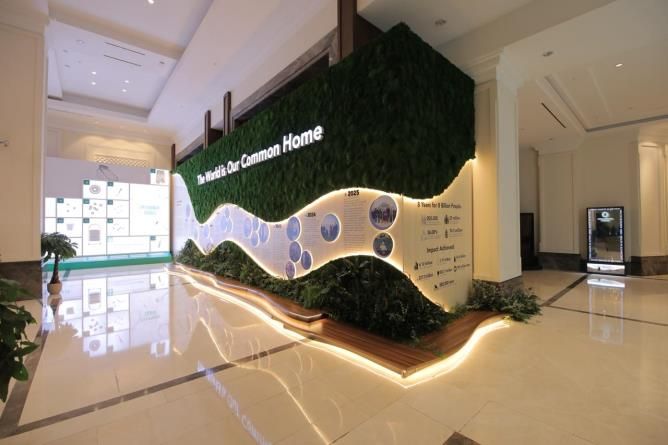 Green and white event display in a hotel foyer