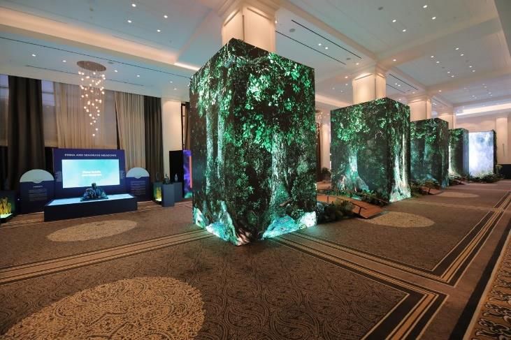 Green decorative columns and a stage in a conference room