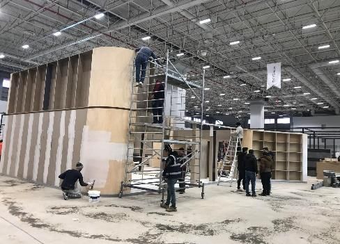Crew building an exhibition stand using scaffolding